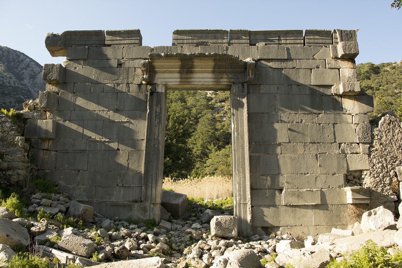 a stone building with a doorway in the middle of it, by Edward Ben Avram, flickr, wall structure, turkey, ancient ruins in the forest, front perspective