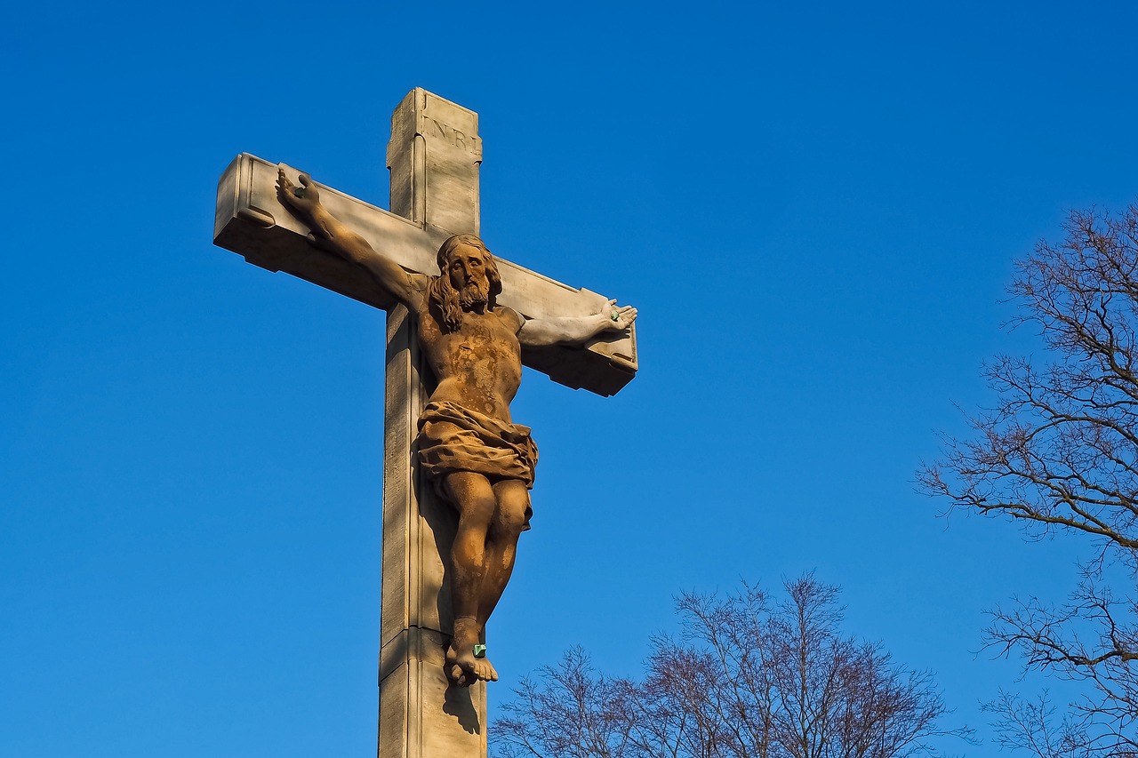 a statue of jesus on a cross with trees in the background, by Charles Gleyre, shutterstock, at highgate cemetery, istockphoto, from wheaton illinois, wooden