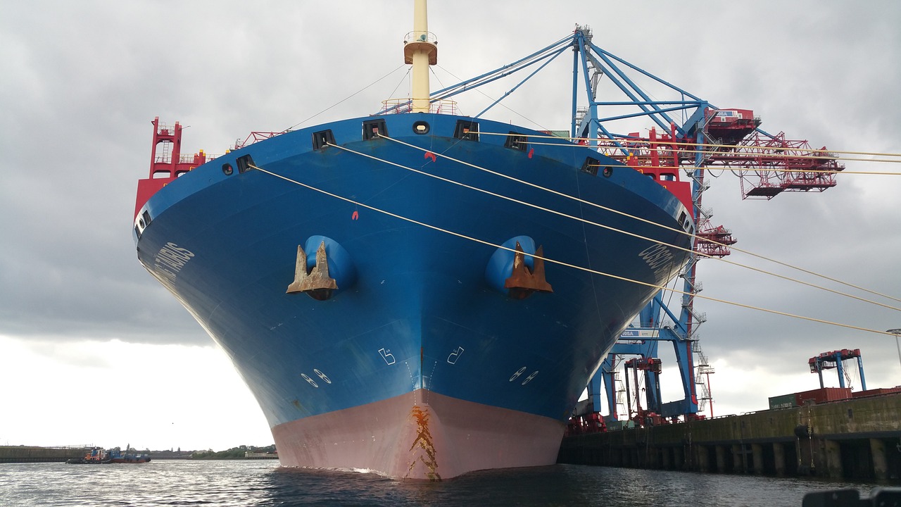 a large blue ship sitting on top of a body of water, a portrait, by Robert Zünd, flickr, thick bow, port city, bottom angle, jamie coreth