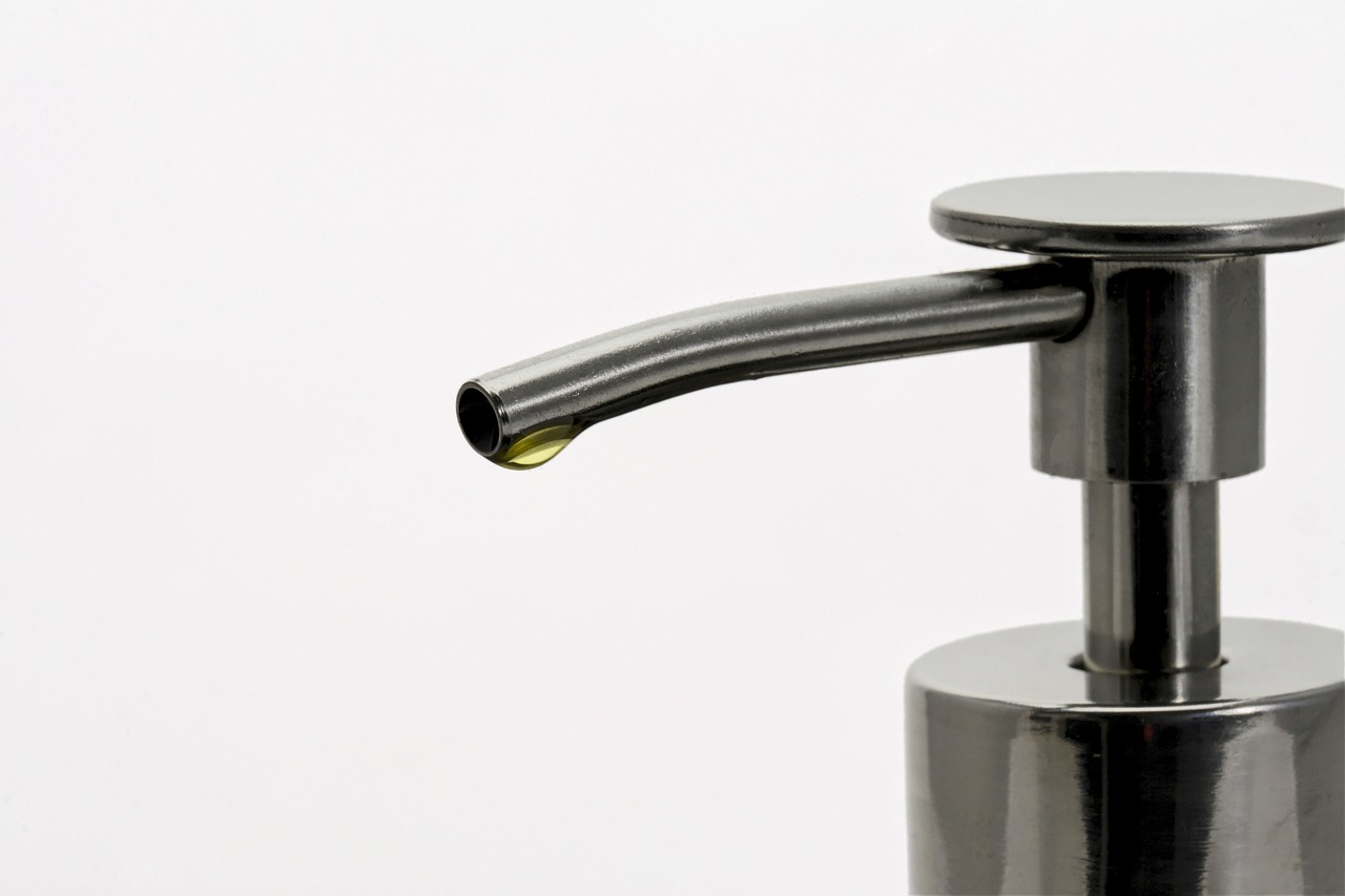 a soap dispenser sitting on top of a counter, by Jan Kupecký, close-up product photo, oil lines, detailed product photo, steel