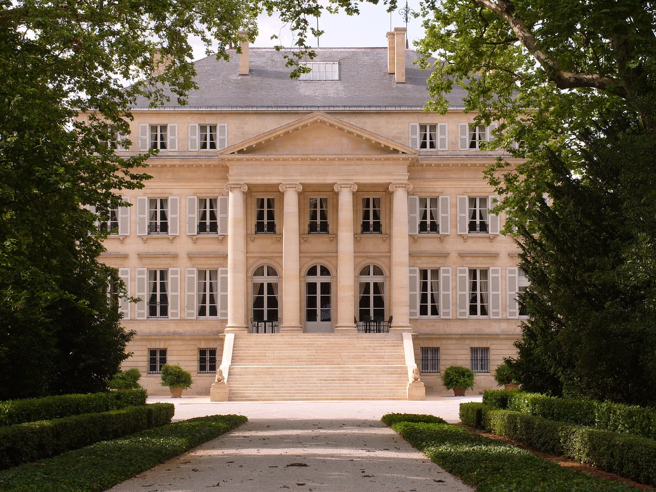 a large stone building surrounded by trees and bushes, inspired by François Barraud, flickr, paris school, beautifully symmetrical, pur champagne damery, luxury and elite, exterior view