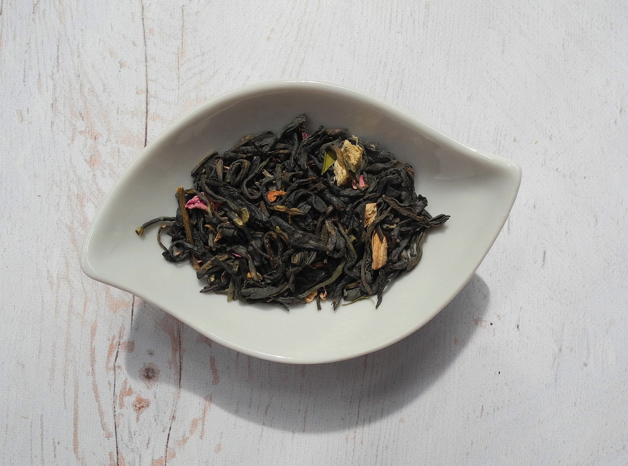 a white bowl filled with green tea on top of a wooden table, inspired by George Lambourn, hurufiyya, natural point rose', black lotus, coloured, jasmine