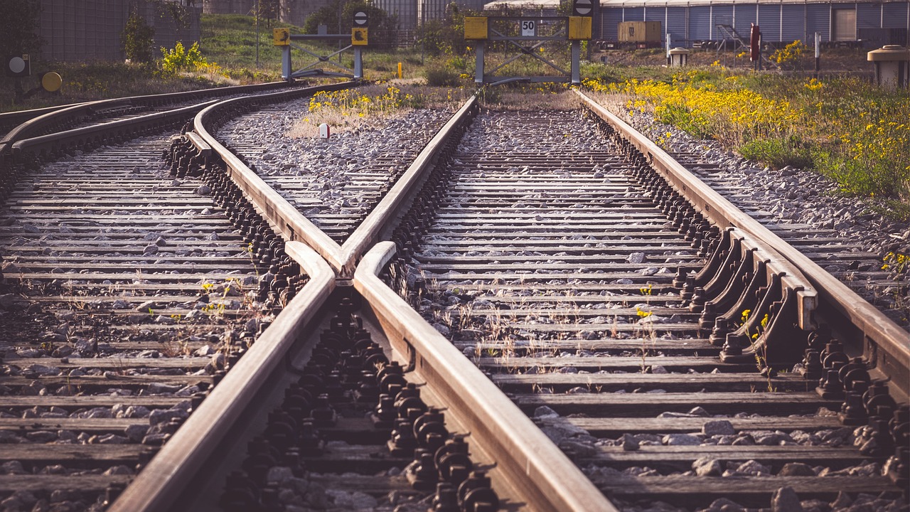 a couple of train tracks that are next to each other, a picture, by Richard Carline, bended forward, intercrossed, shorting, authoritative