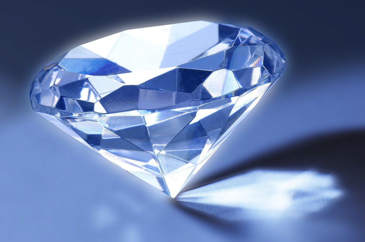 a close up of a diamond on a table, a photo, crystal cubism, strong blue rimlit, fully rendered light to shadow, supersharp photo