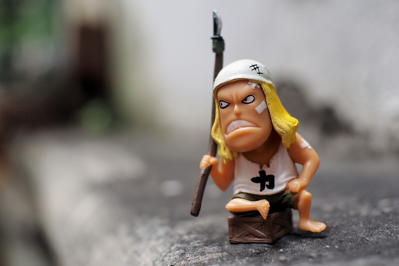 a close up of a figurine of a man with a sword, inspired by Eiichiro Oda, unsplash, one caveman is cowering in fear, sitting on the ground, annoyed expression, biopunk toys made in china