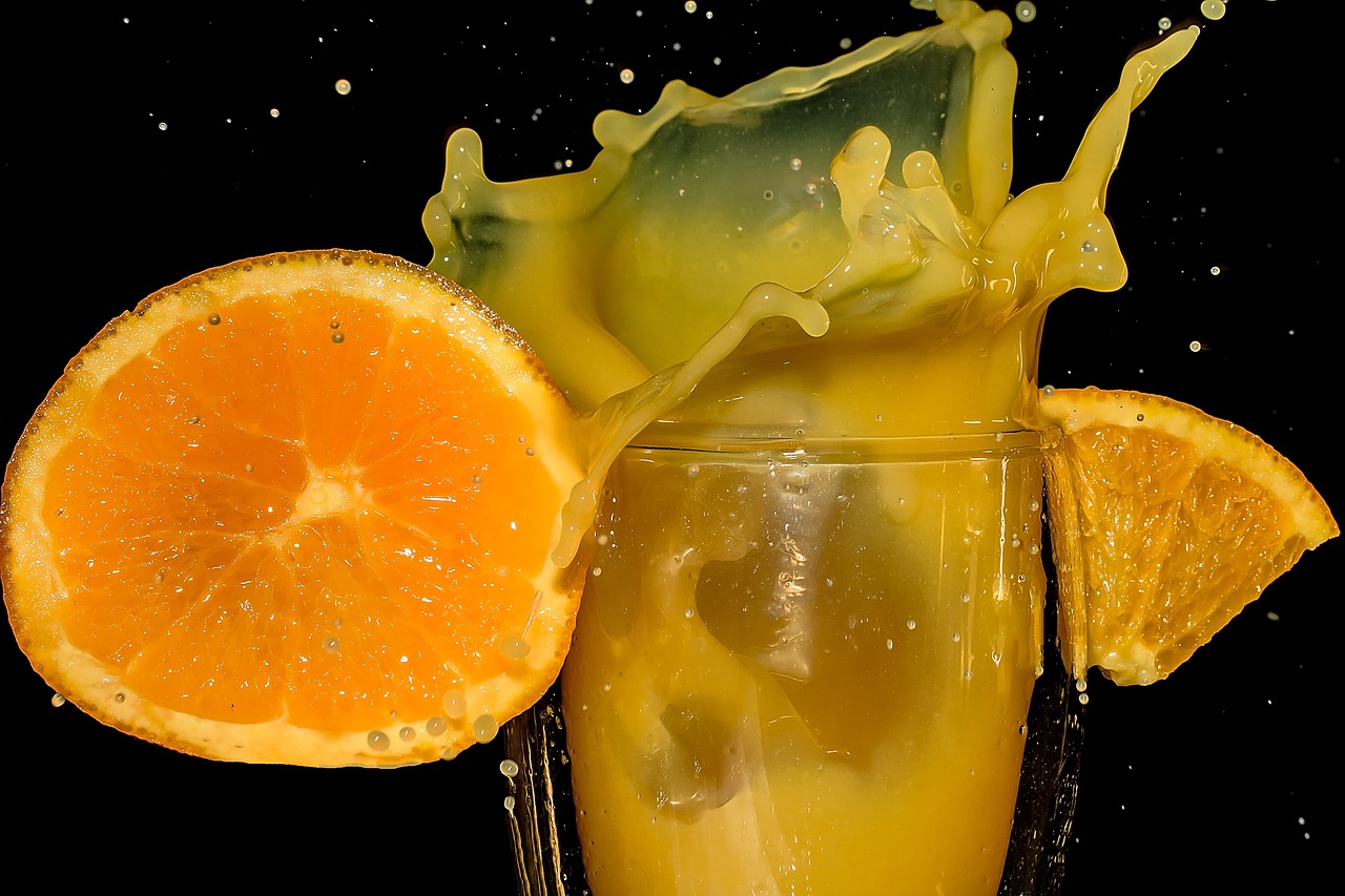 a glass of orange juice next to an orange slice, by Jan Rustem, pexels, photorealism, vanilla smoothie explosion, action shot, age 2 0, crazy fun