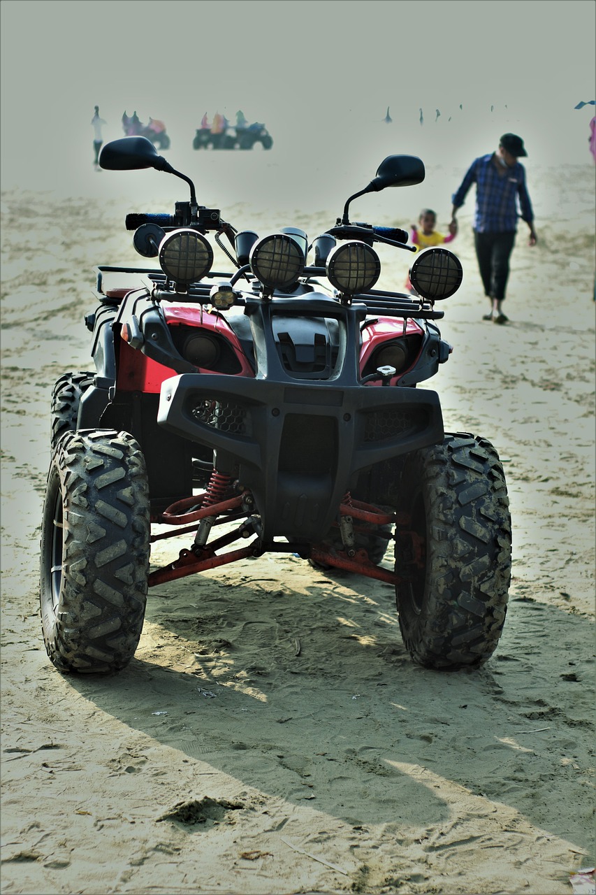 a red four wheeler parked on top of a sandy beach, a portrait, pixabay, cobra, symmetry!! full shot!!, rugged details, back lit, full - body - front - shot
