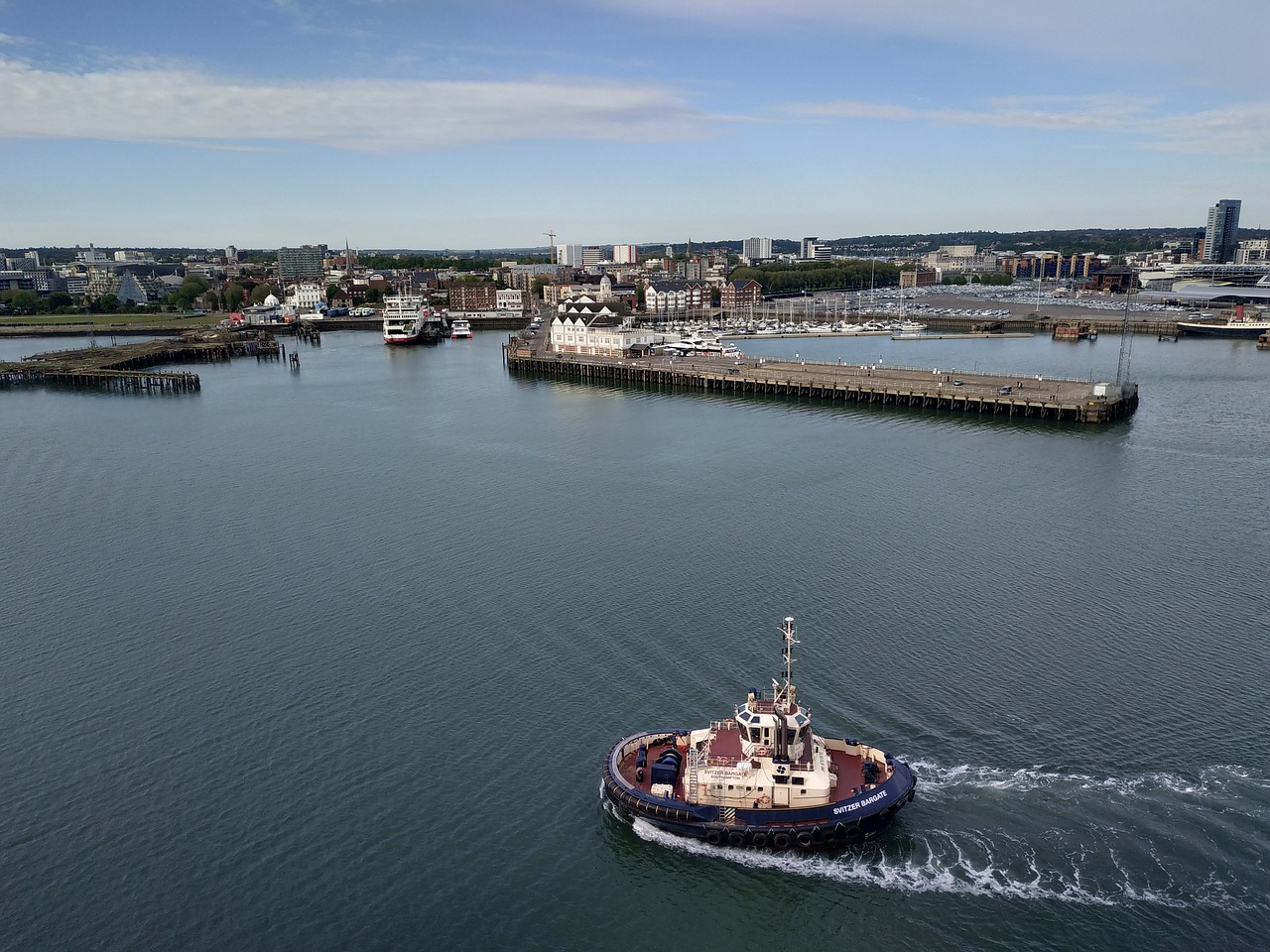 a large boat traveling across a large body of water, by Ian Fairweather, city docks, drone wide shot, hestiasula head, david febland