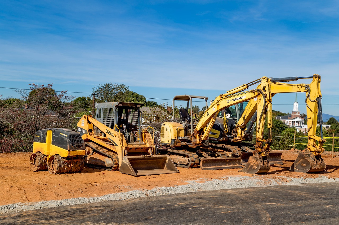 a bulldozer is parked on the side of the road, a photo, by Robert Richenburg, shutterstock, crates and parts on the ground, construction yard, saws, trio