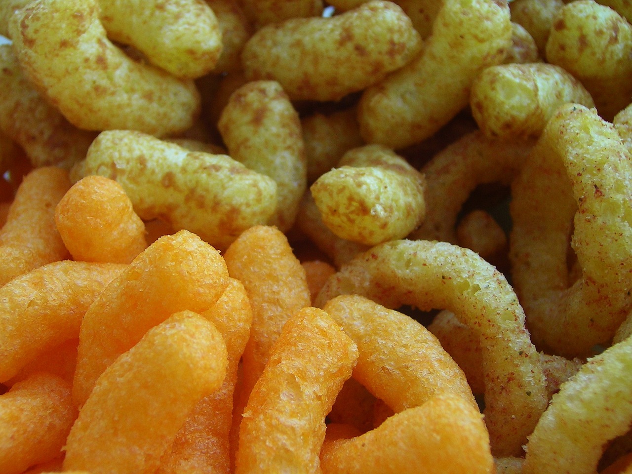 a pile of cheetoes sitting on top of a plate, a macro photograph, by Edward Corbett, realism, yin yang, maze, fry, closeup at the food