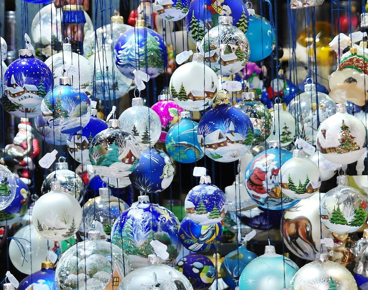 a bunch of christmas ornaments hanging from strings, a photo, inspired by Ludwig Knaus, flickr, cloisonnism, paint-on-glass painting, tourist photo, blue! and white colors, the vibrant echoes of the market