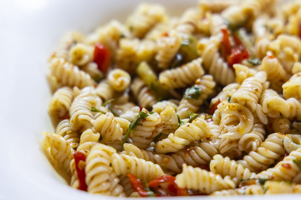 a white bowl filled with pasta and vegetables, a picture, by Matt Cavotta, dynamic closeup, spicy, pepper, relish