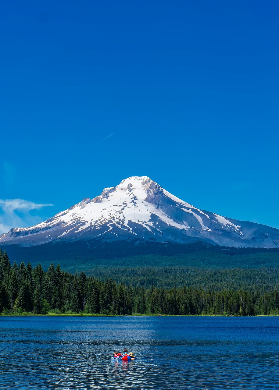 a body of water with a mountain in the background, a photo, shutterstock, portland oregon, with snow on its peak, usa-sep 20, giant imposing mountain