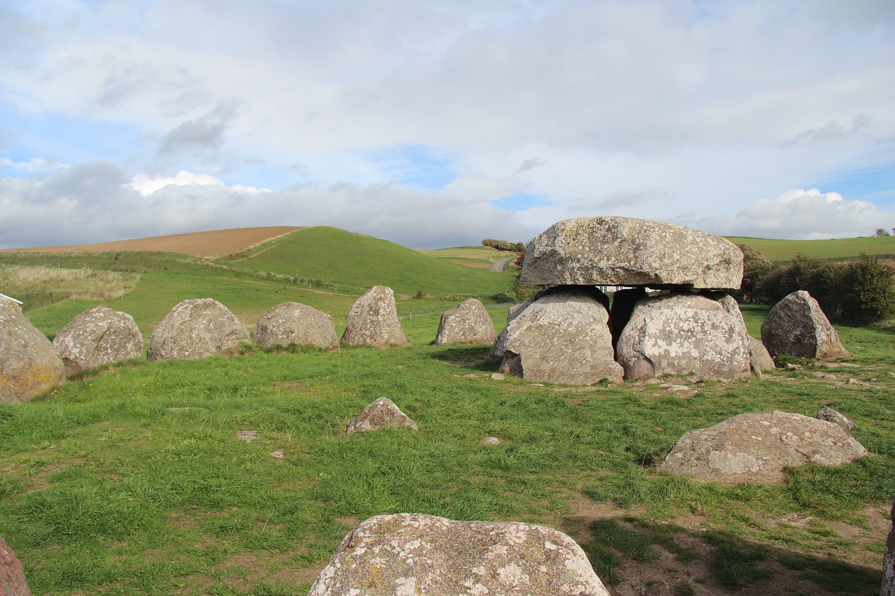 a group of large rocks sitting on top of a lush green field, by Joseph Henderson, flickr, in an ancient vault, ham, 3 doors, van