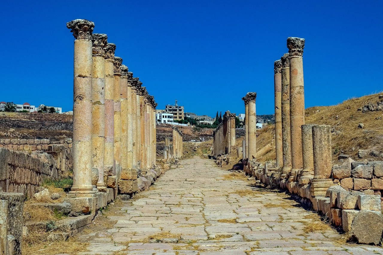 a stone path between two stone pillars with buildings in the background, by Alexis Grimou, jordan, old roman style, view from the distance, hercules