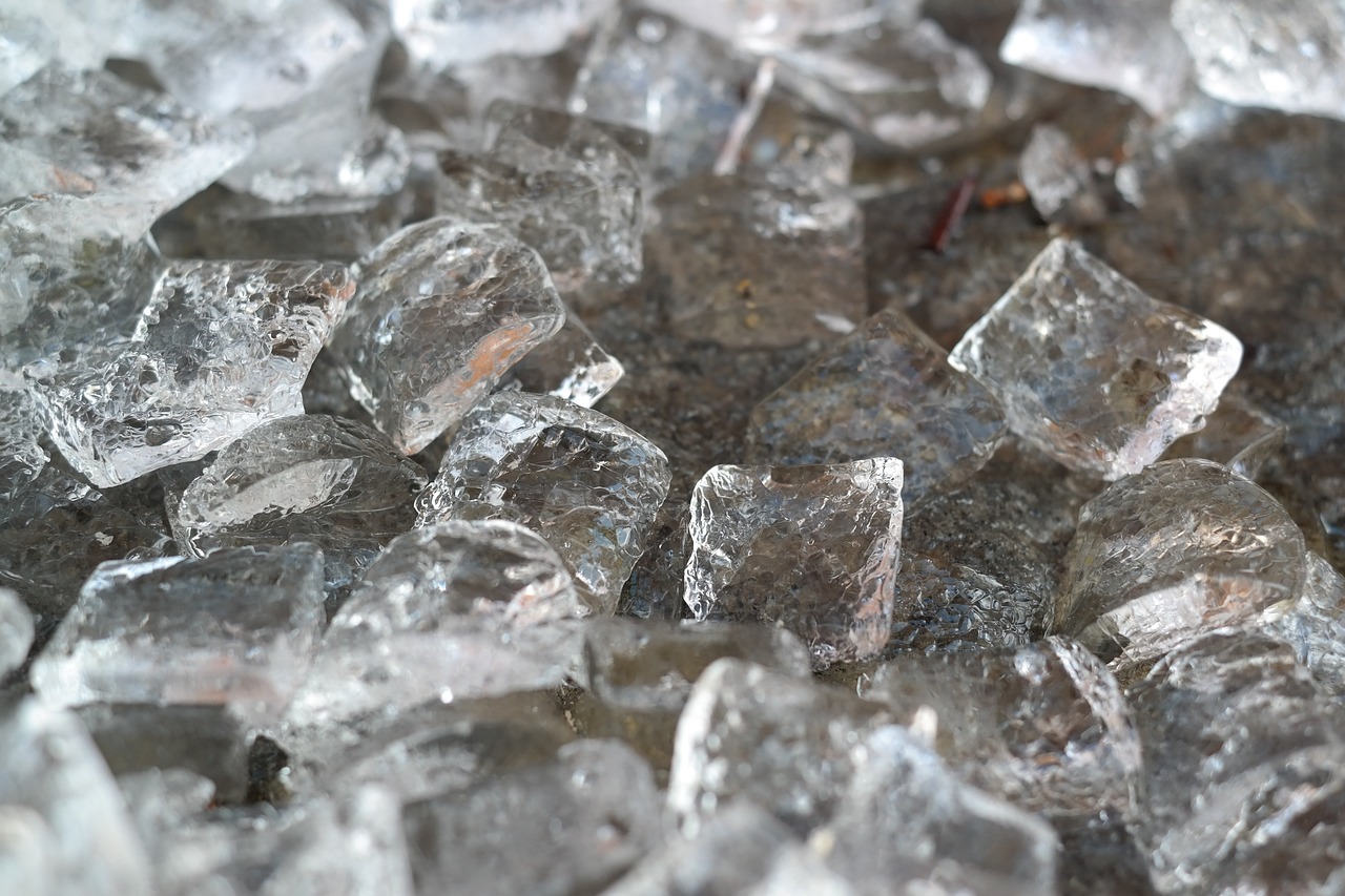 a pile of ice sitting on top of a table, a macro photograph, inspired by Bruno Liljefors, pixabay, glass mosaic, gray, istock, high temperature