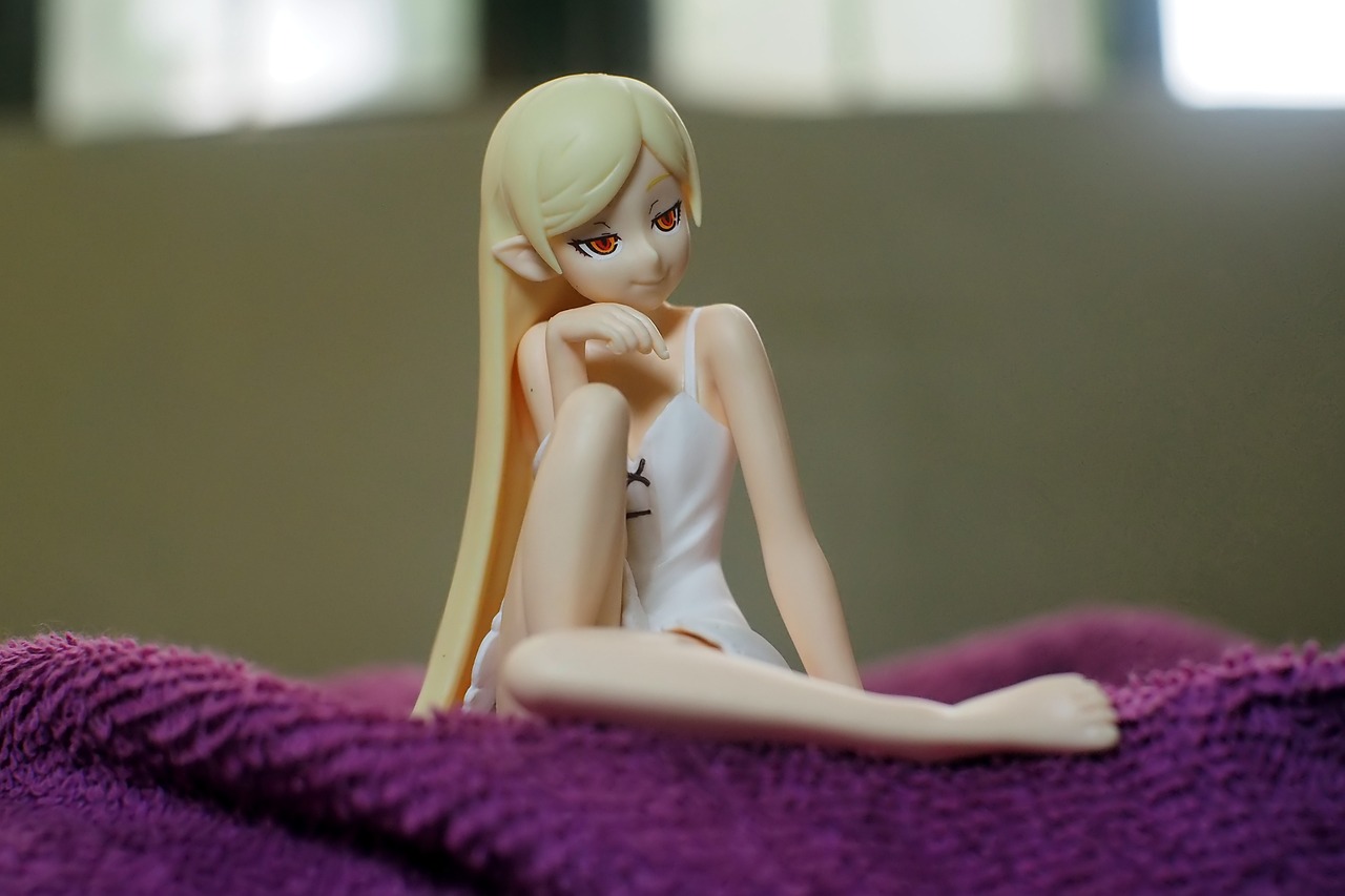 a doll sitting on top of a purple blanket, a statue, inspired by INO, tumblr, model エリサヘス s from acquamodels, shiny white skin, ehime, close up to a skinny