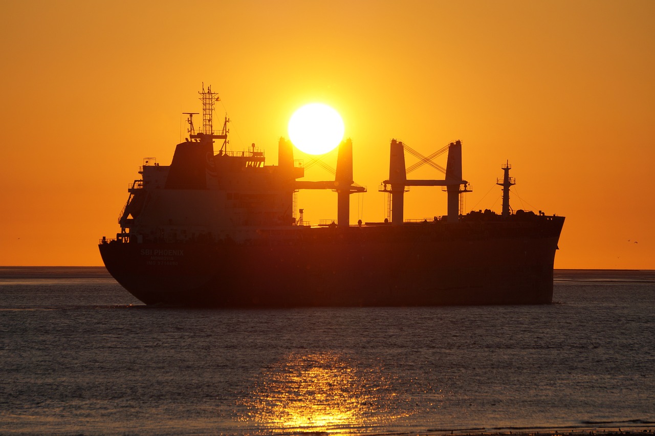 a large ship sitting on top of a body of water, a picture, by Ian Fairweather, pixabay, blocking the sun, crude, siluette, shot on 1 5 0 mm