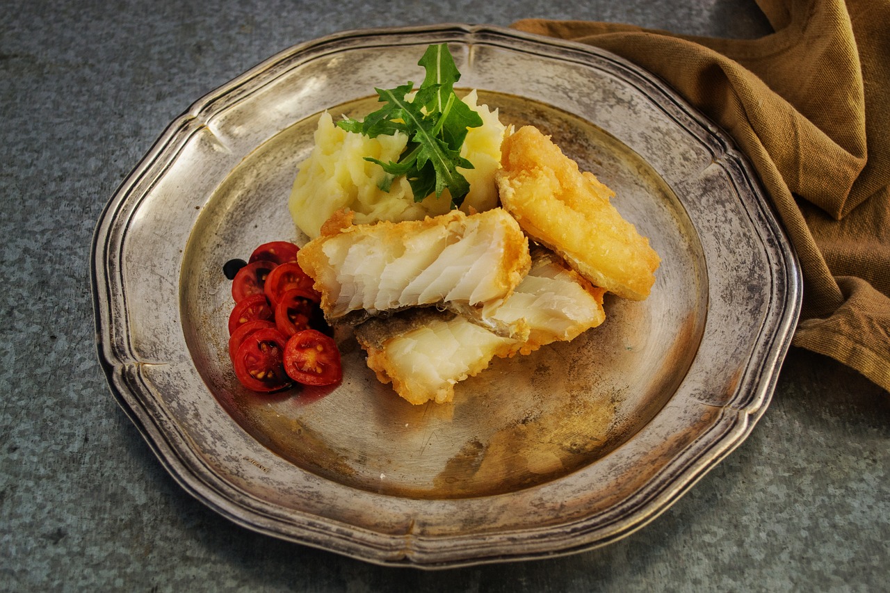 a close up of a plate of food on a table, by Dietmar Damerau, pixabay, art deco, incredibly detailed atlantic cod, battered, high res photo, trio