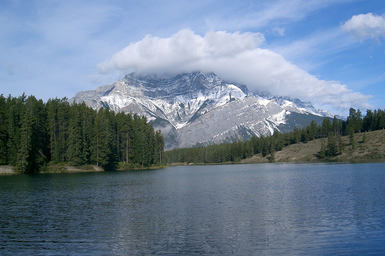 a body of water with a mountain in the background, by Brigette Barrager, flickr, romanticism, banff national park, cumulus, wikimedia commons, blonde