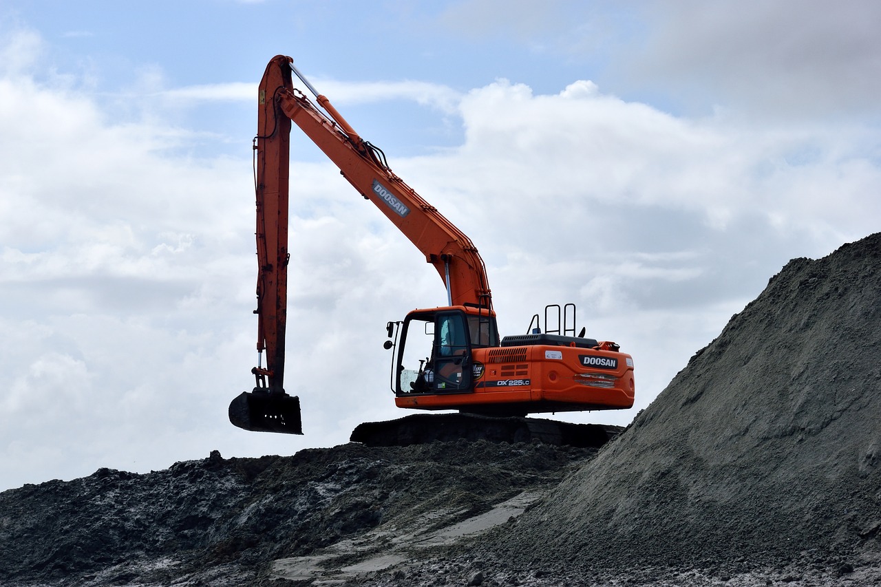 a large orange excavator sitting on top of a pile of dirt, coal, photograph taken in 2 0 2 0, 3 4 5 3 1, manual