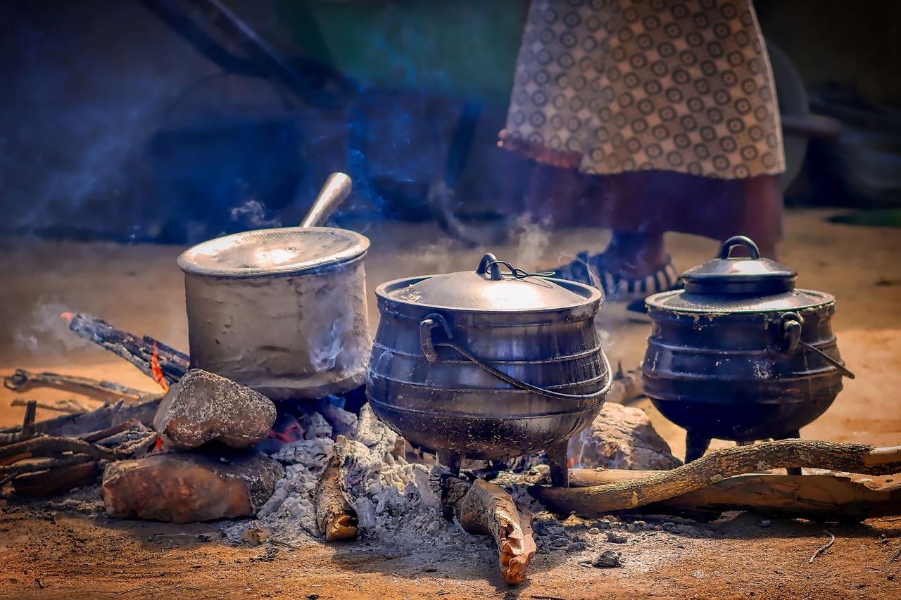 a couple of pots sitting on top of a fire, by Dietmar Damerau, pixabay contest winner, dau-al-set, unmistakably kenyan, breakfast, 🤠 using a 🖥, woman