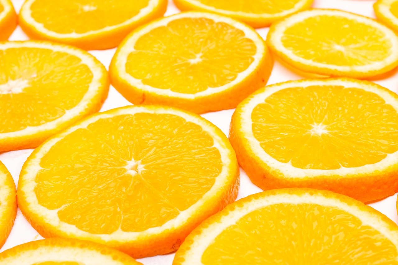 a pile of sliced oranges sitting on top of a table, a stock photo, pexels, high key detailed, wallpaper mobile, the background is white, multiple suns