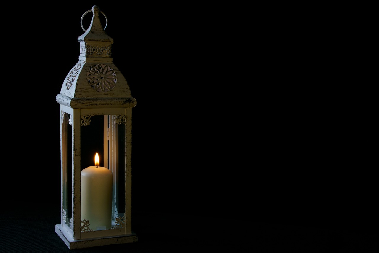 a lit candle in a white lantern on a black background, by Tom Carapic, romanticism, antique, daily render, summer lighting, wide shot photo