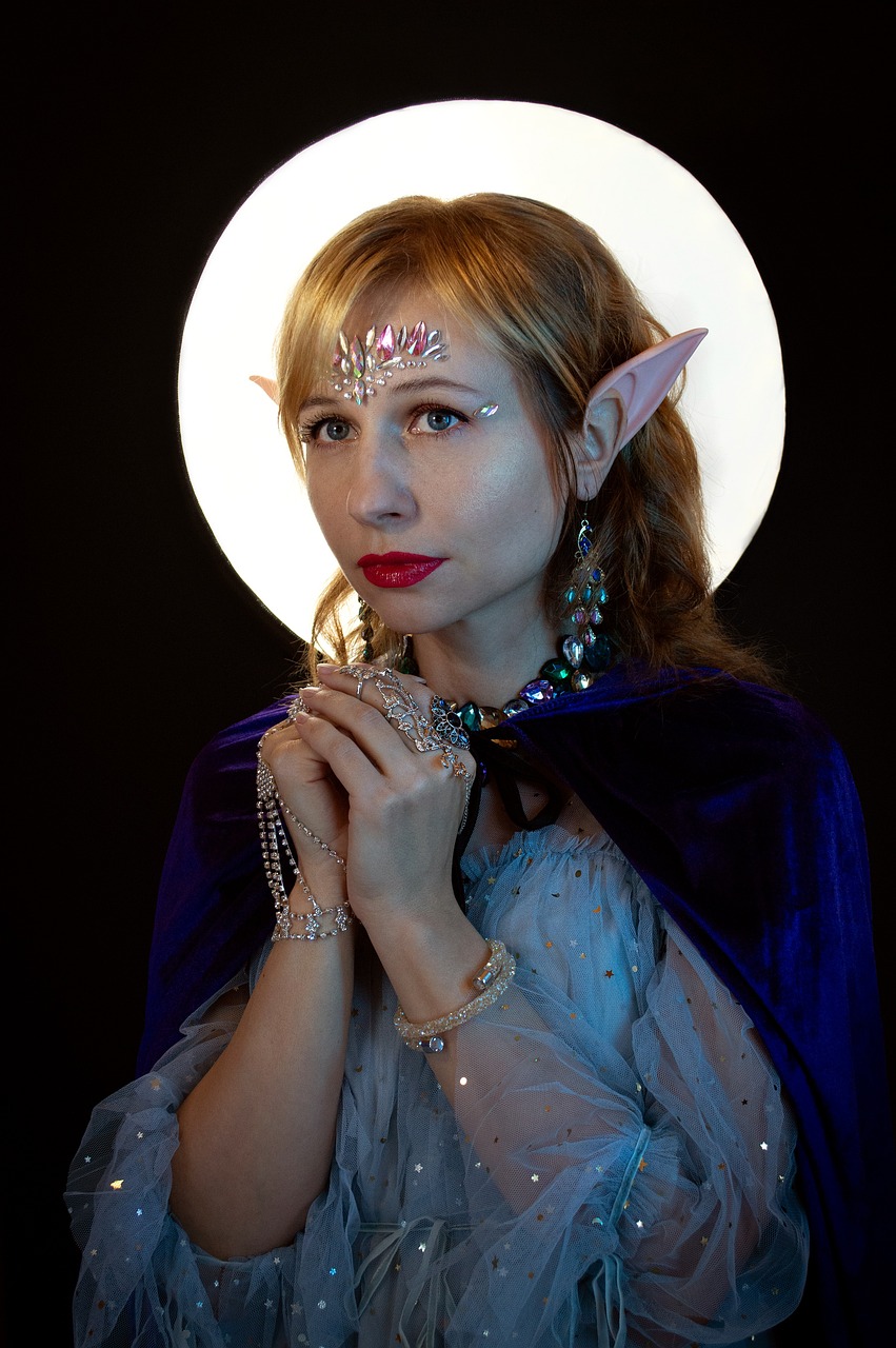 a woman dressed as a elf poses for a picture, a character portrait, inspired by Harry Clarke, reddit, fantasy art, shiny jewels, portrait of princess zelda, twilight ray, two pointed ears