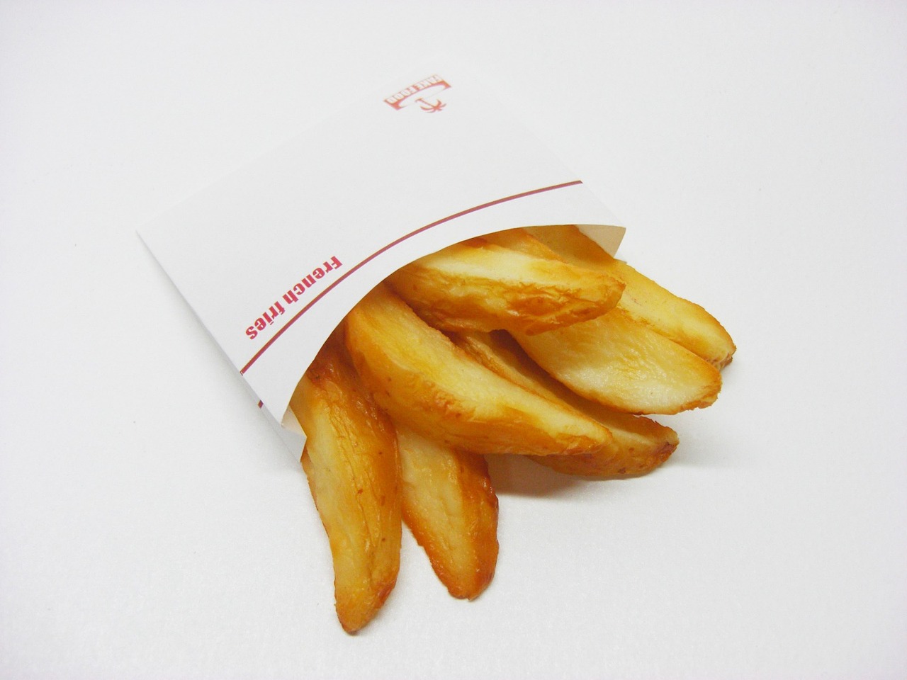 a bag of french fries sitting on top of a table, inspired by Pia Fries, rasquache, on white paper, japan, corners, f 1