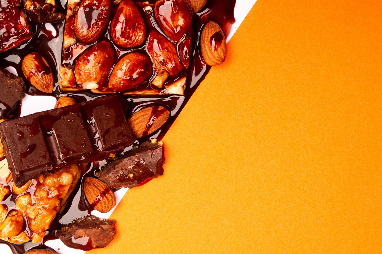 a table topped with lots of different types of chocolate, a stock photo, baroque, on the orange surface of mars, caramel. rugged, hair died to a hazelnut brown, high angle close up shot