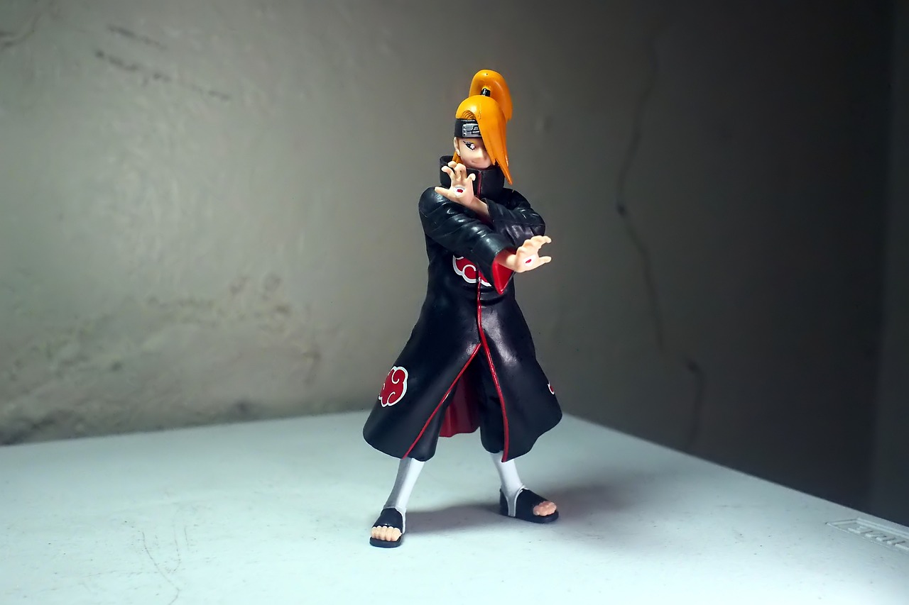 a close up of a toy figure on a table, shin hanga, pain from naruto, full body black and red longcoat, portrait mode photo, uzumaki