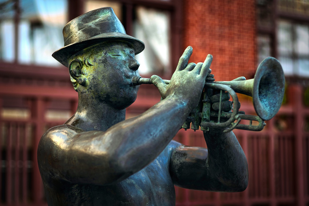 a bronze statue of a man playing a trumpet, by Dave Melvin, pixabay contest winner, harlem renaissance, fine detail post processing, boston, two horns on the head, with a glass eye and a top hat