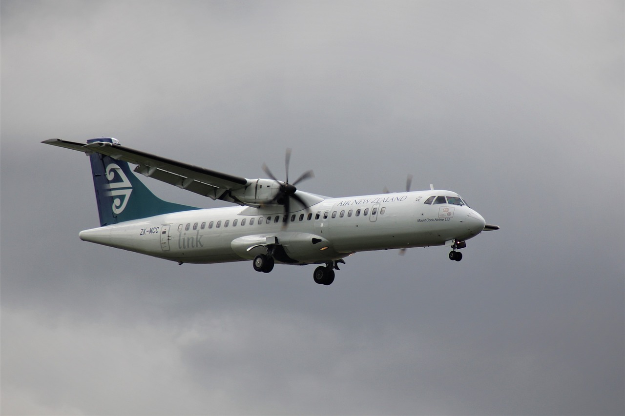 a large jetliner flying through a cloudy sky, a picture, by Alexander Robertson, hurufiyya, teals, abraham teerlink, kahikatea, head and shoulder shot