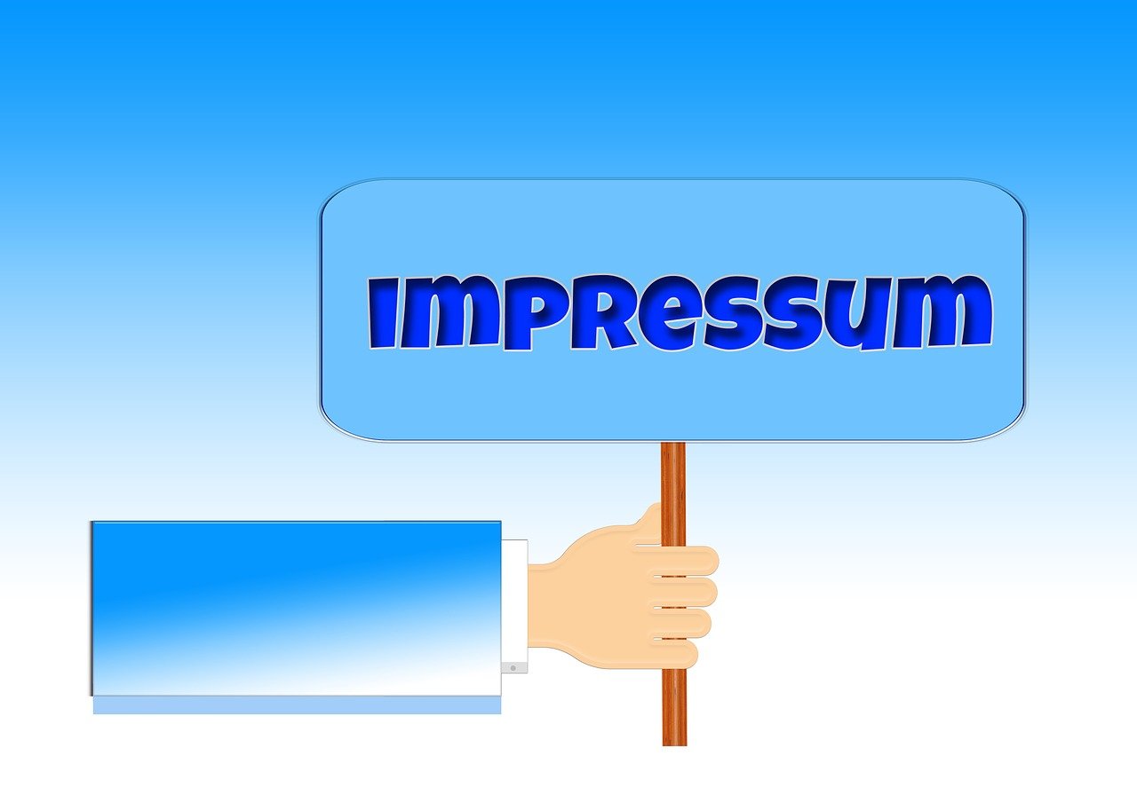 a hand holding a sign that says imppressum, impressionism, vector, profesional photo