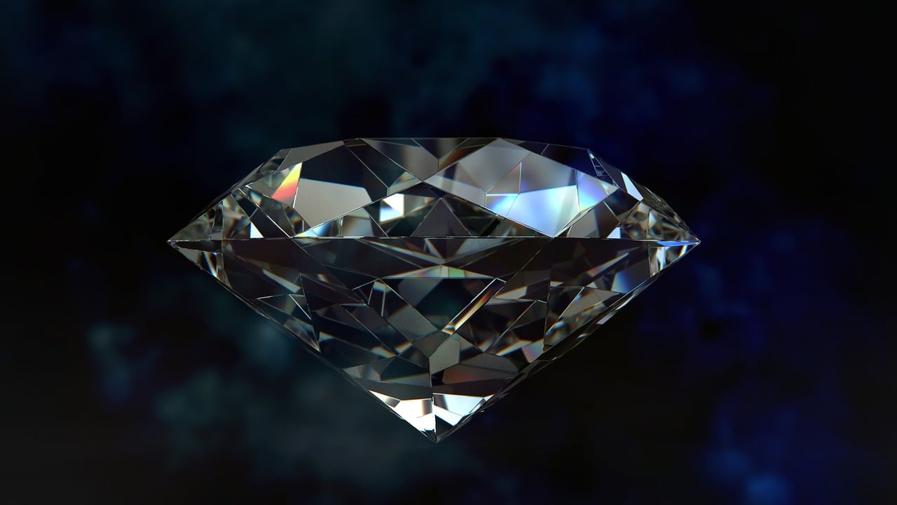 a close up of a diamond on a blue background, by Adam Szentpétery, pixabay, on a dark background, super-realistic, with crystals on the walls, red emerald