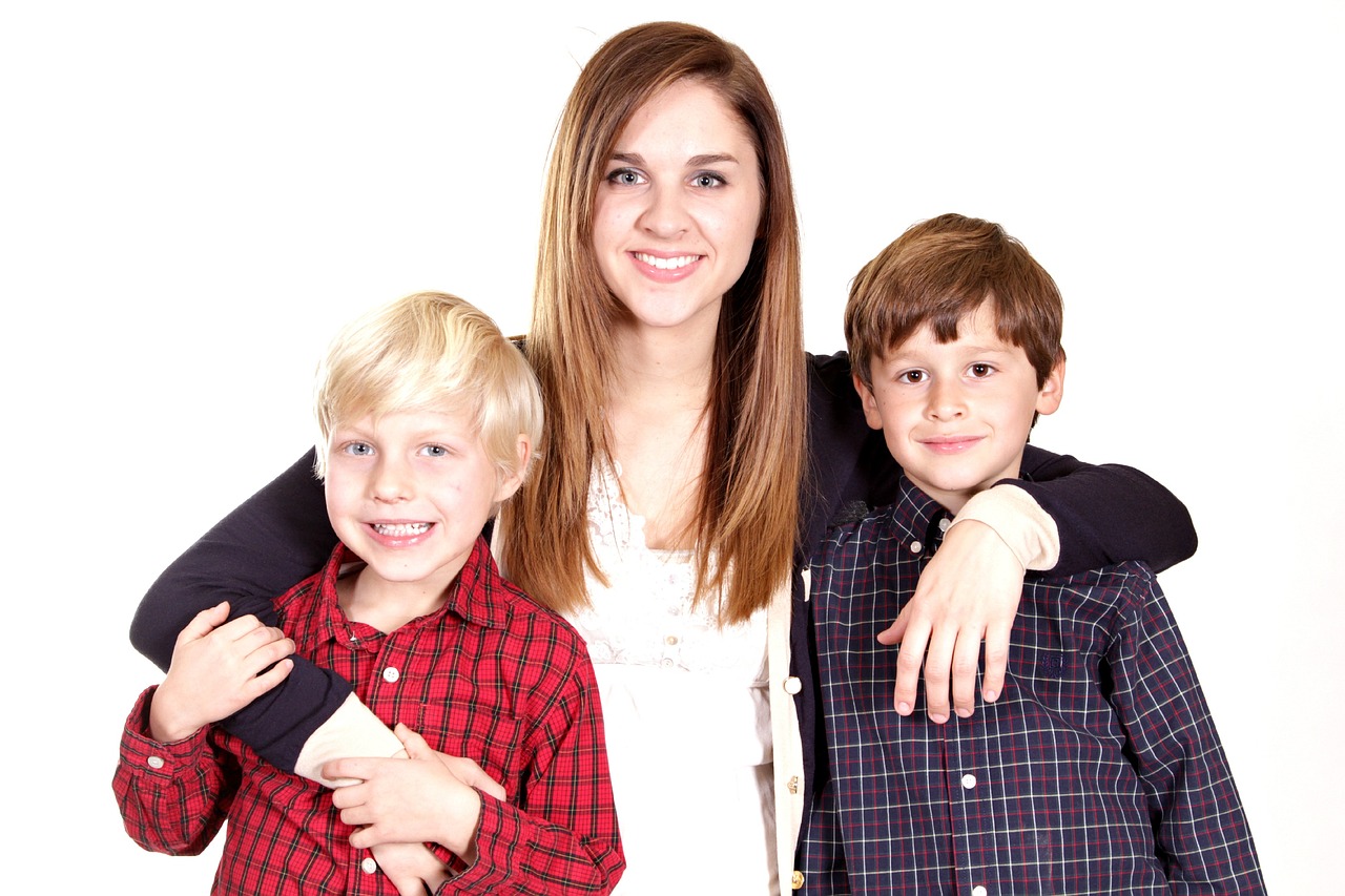 a woman and two boys posing for a picture, pixabay, incoherents, white bg, handsome girl, at home, fine detailing