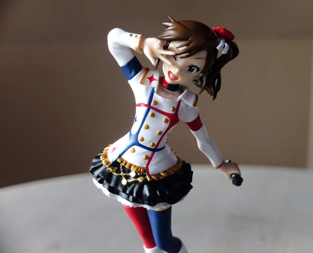 a close up of a figurine of a woman, inspired by Fujiwara Takanobu, cg society contest winner, wearing rr diner uniform, as though she is dancing, very very low quality picture, full body photogenic shot