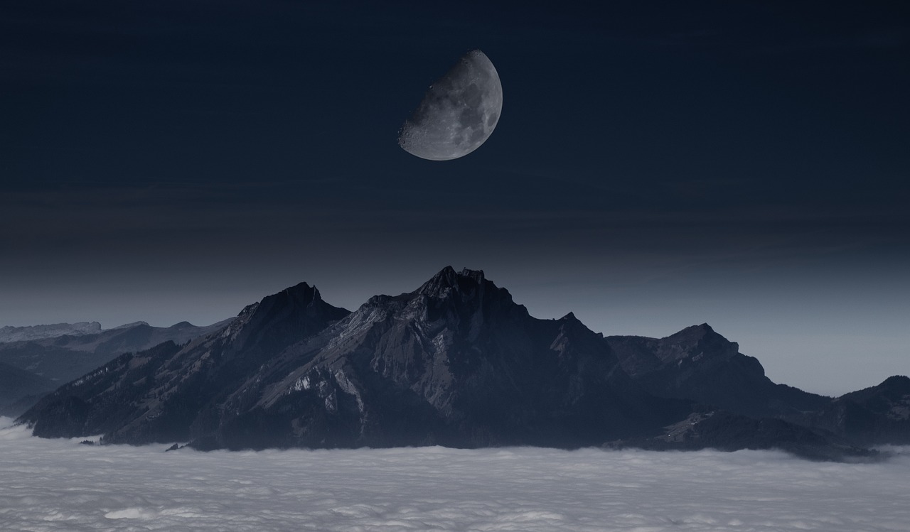 the moon is rising over the mountains above the clouds, inspired by Michal Karcz, romanticism, photo mid shot, half moon, midnight-blue, “ aerial view of a mountain