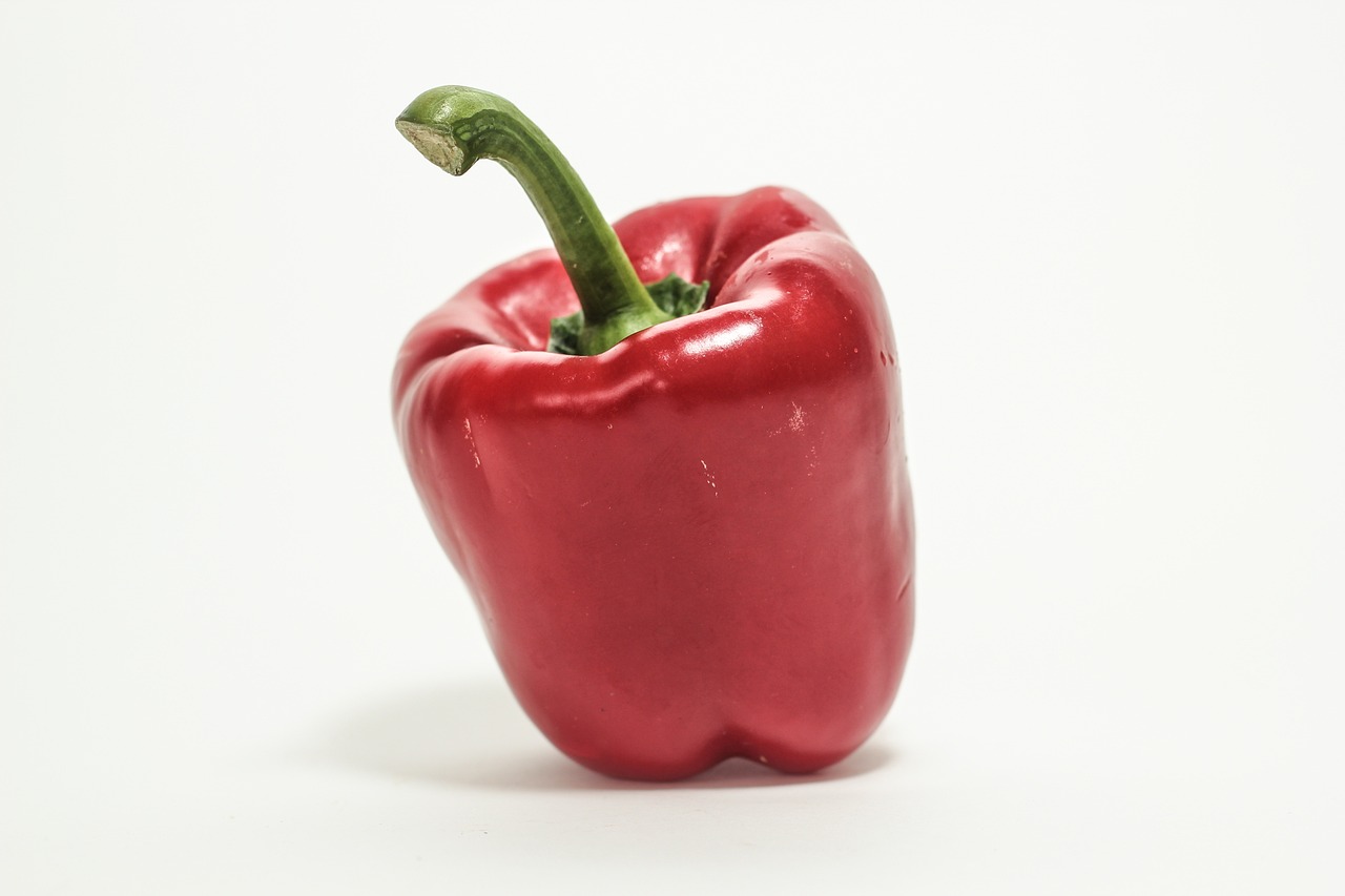 a red pepper sitting on top of a white surface, a picture, renaissance, zun, about 3 5 years old, annie leibowit, highresolution
