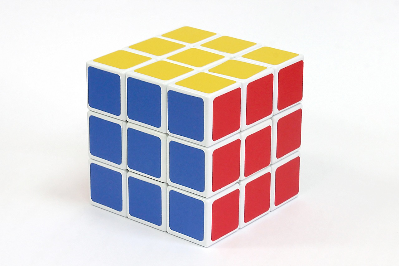 a rubik cube sitting on top of a white surface, inspired by Ernő Rubik, 3 colour, white cyc, [ [ soft ] ], high qualit