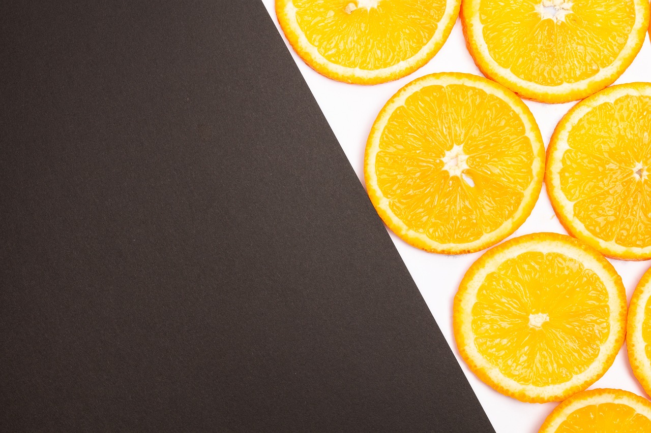 a close up of sliced oranges on a black and white background, a stock photo, by Juan O'Gorman, pexels, minimalism, banner, on white paper, miniature product photo, background image