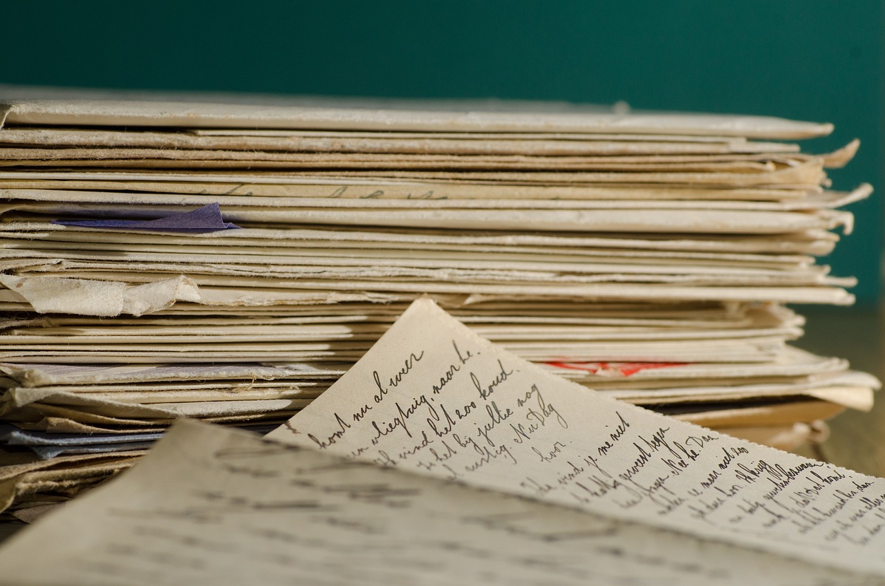 a stack of papers sitting on top of a table, a portrait, flickr, letterism, museum archive, writing in journal, closeup photo, photograph credit: ap