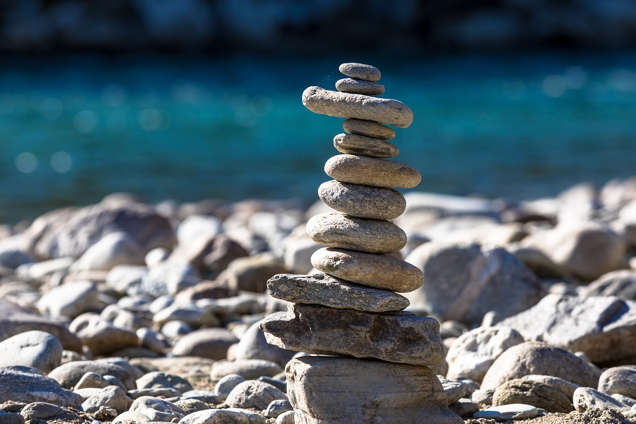 a pile of rocks sitting on top of a rocky beach, balance and proportional, tapping in to something greater, stepping on towers, rivers