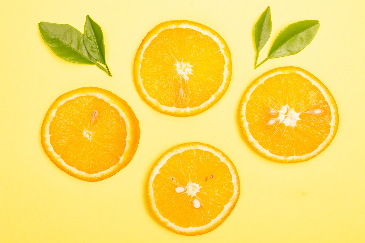 four slices of orange with leaves on a yellow background, by Joseph-Marie Vien, trending on pixabay, background image, 🐿🍸🍋, skincare, 🦩🪐🐞👩🏻🦳