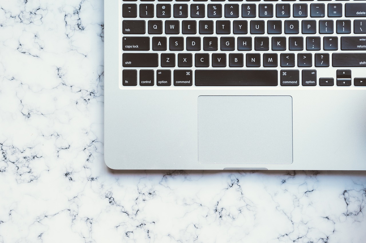 a laptop computer sitting on top of a marble table, by Carey Morris, pexels, viewed from above, keyboard, background image, nongraphic