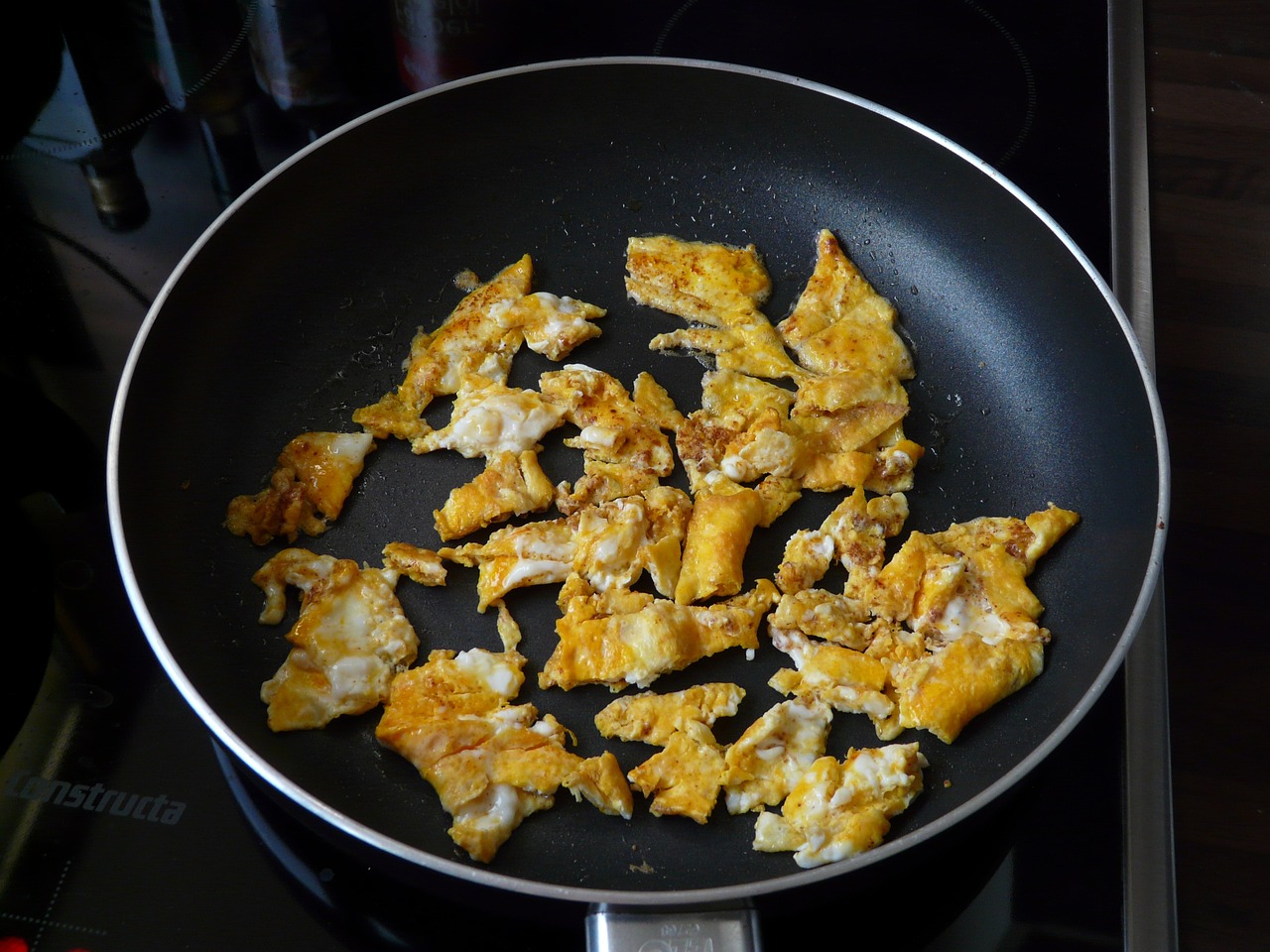 a frying pan filled with food sitting on top of a stove, inspired by Carpoforo Tencalla, fish skin, tessellation, battered, ripped to shreds