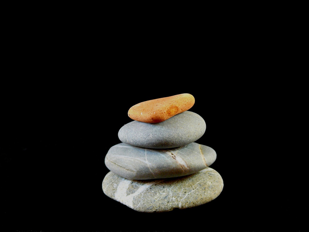 a stack of rocks sitting on top of each other, minimalism, 2000s photo, on black background, woodstock, miniature product photo