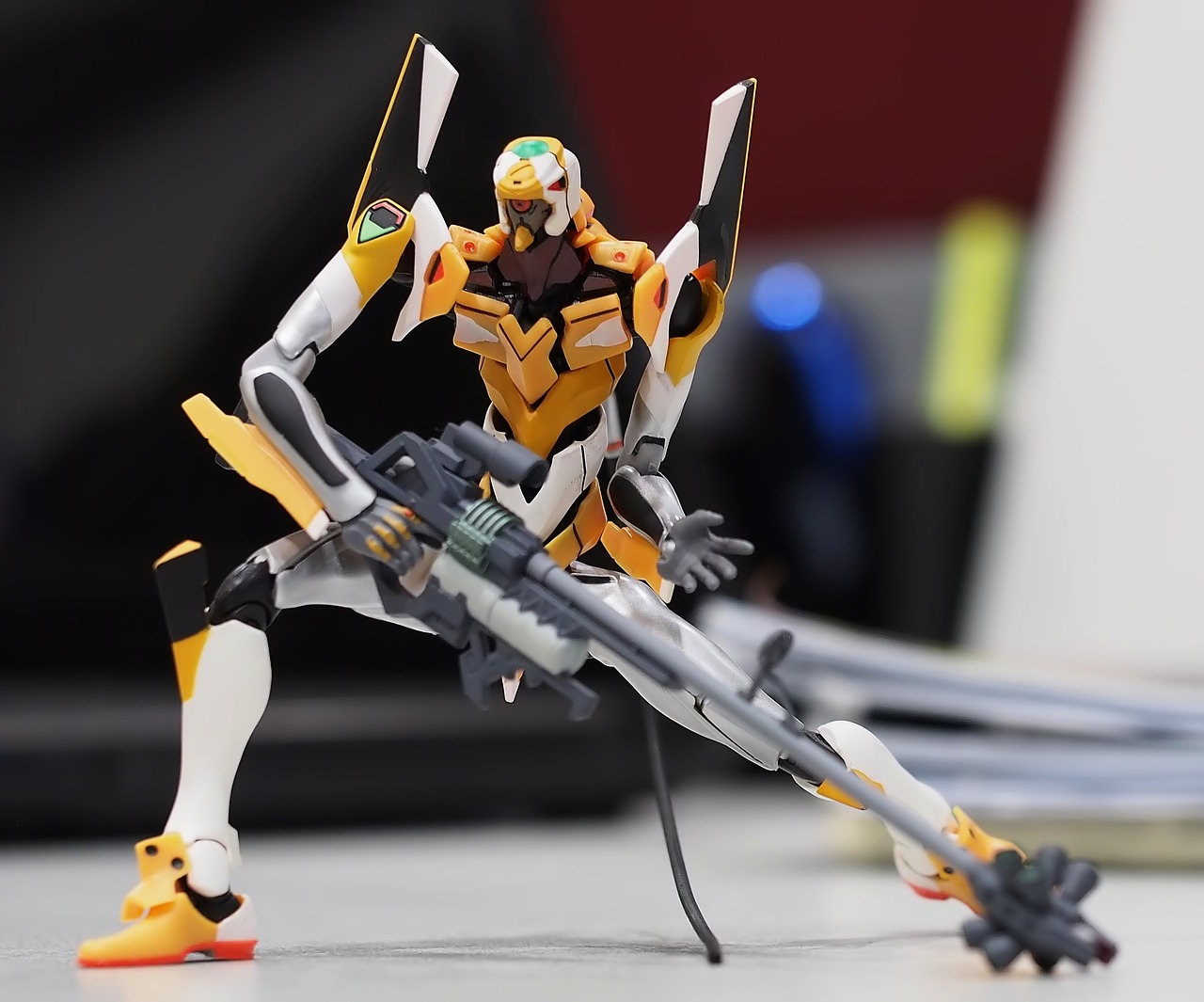 a close up of a toy on a table, inspired by Yoshiyuki Tomino, figuration libre, eva unit 0 1, action poses with weapons, genji, very longshot