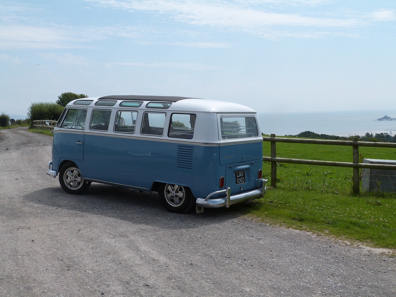 a blue and white van parked on the side of a road, a picture, by Edward Corbett, flickr, retrofuturism, seaview, big windows, glamping, view from the side”